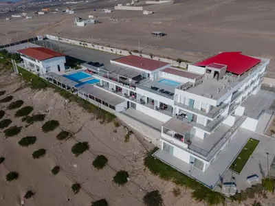 an overhead view of a white building with a swimming pool at Vista a Mar in Huaral