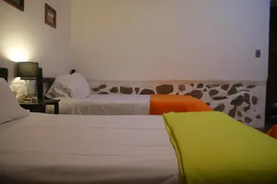a hotel room with two beds at Hotel Samanapaq in Ollantaytambo
