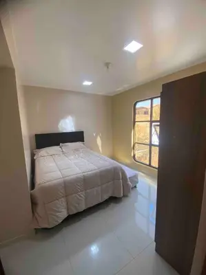 a bedroom with a bed and a window at Casa Elizabeth in Huancayo