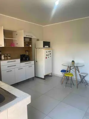 a kitchen with a white refrigerator and a table at Casa Elizabeth in Huancayo