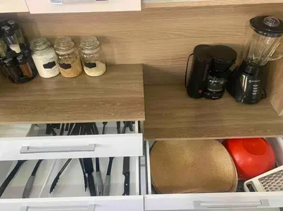 a cupboard with jars of food and utensils at Casa Elizabeth in Huancayo