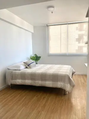 a bedroom with a bed in a room with a window at Vista Brasil Dúplex in Lima