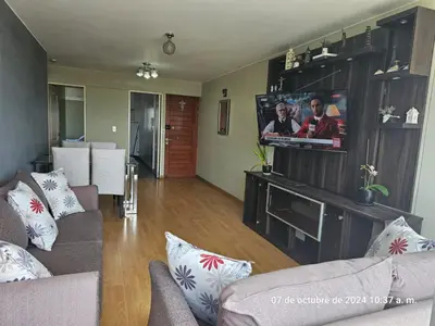 a living room with a couch and a flat screen tv at Departamento Pueblo Libre in Lima