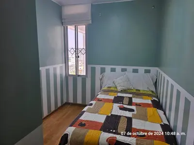 a bedroom with a bed with a quilt on it at Departamento Pueblo Libre in Lima