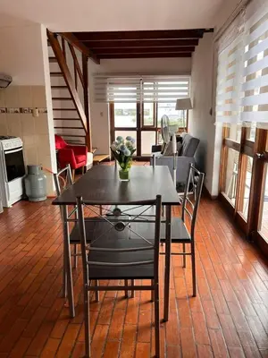 a dining table and chairs in a living room at MONTERRICO POLO APARTS #4 - Dpto Completo Familiar 2 camas a una cuadra Embajada USA in Lima
