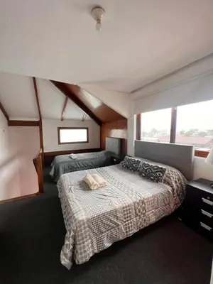 a bedroom with two beds and a large window at MONTERRICO POLO APARTS #4 - Dpto Completo Familiar 2 camas a una cuadra Embajada USA in Lima
