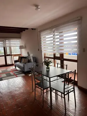 a living room with a table and chairs and a couch at MONTERRICO POLO APARTS #4 - Dpto Completo Familiar 2 camas a una cuadra Embajada USA in Lima