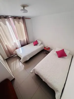 a room with two beds and a window at Loft Huacachina center ica in Ica