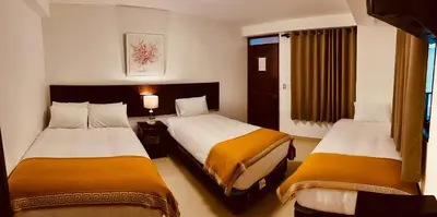 a hotel room with two beds in a room at PisonayMapiHotelBoutique in Machu Picchu