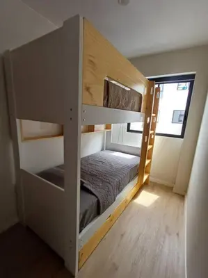 a bunk bed in a small room with a bunk bed in it at Luxurious Apartment Besso in Lima