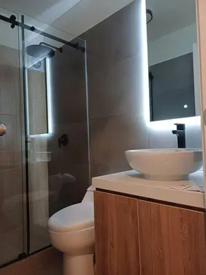 a bathroom with a toilet and a sink and a shower at Luxurious Apartment Besso in Lima