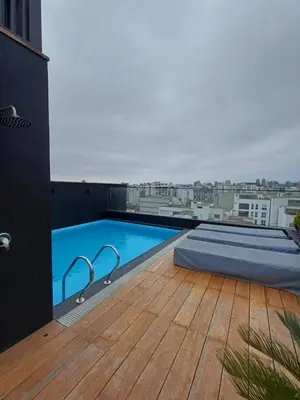 a swimming pool on the roof of a building at Luxurious Apartment Besso in Lima