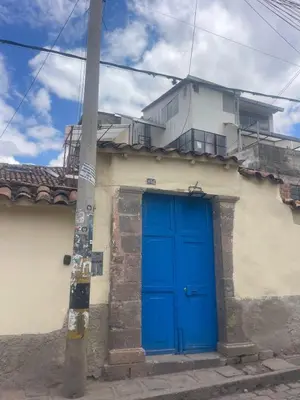 a blue door on the side of a building at Duplex panorámico in Cusco