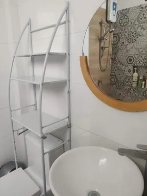 a bathroom with a white toilet and a mirror at Wasi de Sophia in Lima
