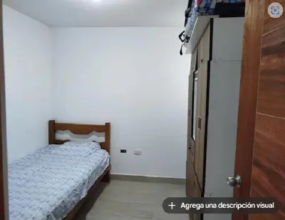 a bedroom with a bed and a white wall at Wasi de Sophia in Lima