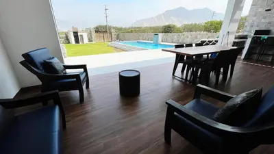 a dining room with a table and chairs and a pool at Cieneguilla Dreams in Cieneguilla