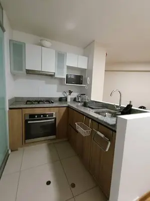 a kitchen with a sink and a stove top oven at Departmento Campo de Marte in Lima