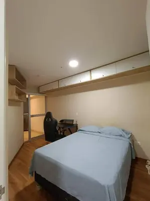a bedroom with a large bed and a desk at Departmento Campo de Marte in Lima