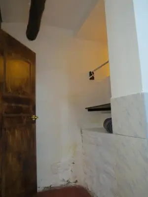 a room with a door and a white wall at La Casa de Abril Cusco in Cusco