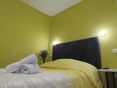 a bedroom with a bed with towels on it at La Casa de Abril Cusco in Cusco