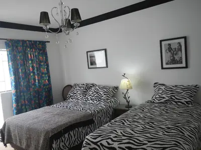 two beds sitting next to each other in a bedroom at Blue Shark Apartments in San Bartolo