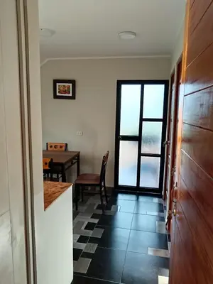 a kitchen and dining room with a table and a window at La Casa de Anni Departamento 2 in Oxapampa