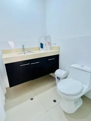 a bathroom with a white toilet and a sink at Amplio, Bonito , Silencioso y céntrico en Miraflores in Lima