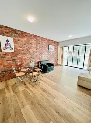 a living room with a brick wall and a table and chairs at Amplio, Bonito , Silencioso y céntrico en Miraflores in Lima