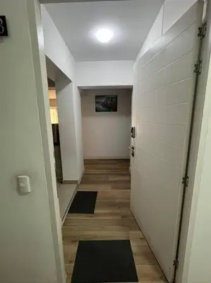 a hallway with two doors and a hallway with mats at Amplio, Bonito , Silencioso y céntrico en Miraflores in Lima