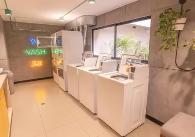 a laundry room with a row of washing machines at Estreno en barranco BR1 in Lima