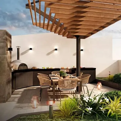 a patio with a table and chairs under a wooden umbrella at Alojamiento Mama Ocllo in Lima