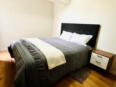 a bedroom with a large bed with a night stand at Alojamiento Mama Ocllo in Lima