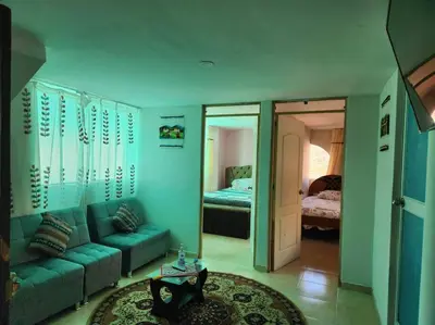 a living room with a couch and a bedroom at Casa Mirador San Blas II in Cusco