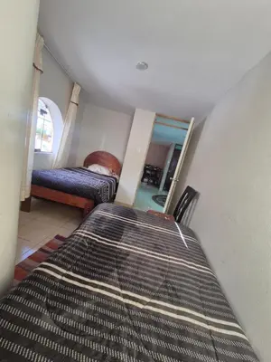 a bedroom with two beds and a mirror at Casa Mirador San Blas II in Cusco