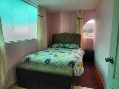 a small bedroom with a bed with a window at Casa Mirador San Blas II in Cusco