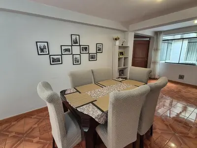 a dining room with a table and chairs at MaKePal Guest House in Cusco