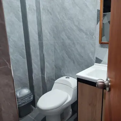 a bathroom with a white toilet and a sink at Hospedaje velilu in Ica