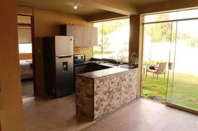 a kitchen with a refrigerator and a counter top at Casa Victoria - Huayllabamba, Urubamba Cusco, Perú in Huayllabamba