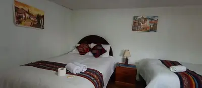 a bedroom with two beds with towels on them at Hospedaje Rosita INN in Cusco