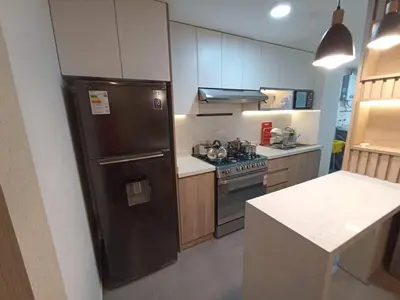 a kitchen with a black refrigerator and a stove at Departamento en estreno Alameda Central in Lima