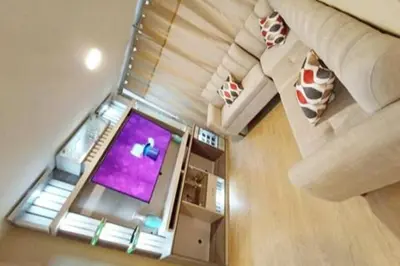 an overhead view of a living room with a tv at Departamento en estreno Alameda Central in Lima