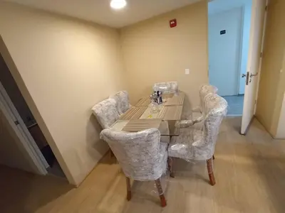 a dining room with a wooden table and chairs at Departamento en estreno Alameda Central in Lima