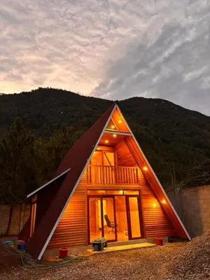 a small house with a triangular roof at Cabañas Polka Oxapampa in Oxapampa
