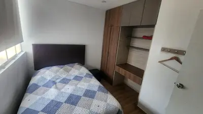 a small bedroom with a bed and a closet at Departamento exclusivo ica in Ica