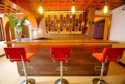 a bar with two red chairs in a room at San Francisco Pardo Hotel in Cusco