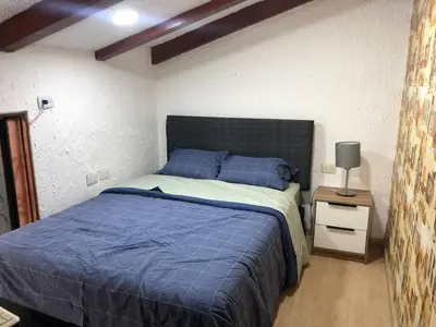 a bedroom with a blue bed and a night stand at Departamento en corazón de Miraflores in Lima