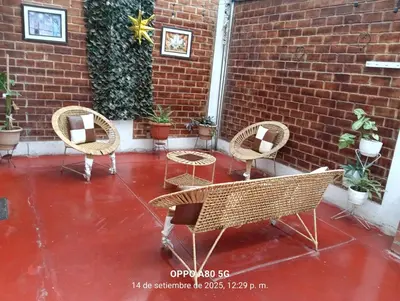 a group of chairs and tables on a patio at Casita de camucha in Chincha Baja