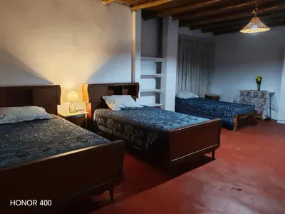 a bedroom with two beds in a room at Casita de camucha in Chincha Baja