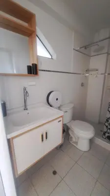 a white bathroom with a toilet and a sink at Habitaciones en la Casa de Dora, 4to y 5to piso in Ayacucho