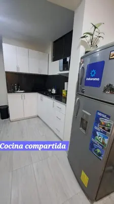 a kitchen with a refrigerator and white cabinets at Habitaciones en la Casa de Dora, 4to y 5to piso in Ayacucho